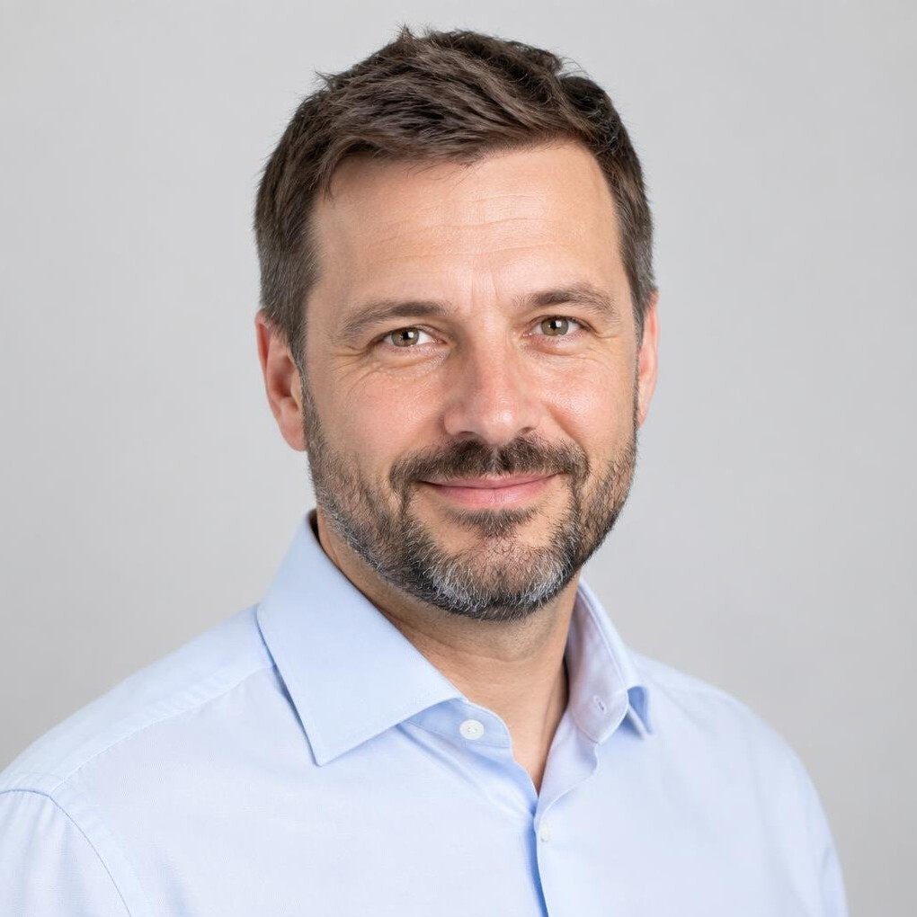 Studio portrait of a bearded Central European man in a business shirt